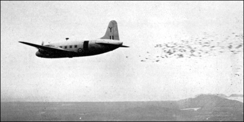 A Royal Air Force Valetta drops leaflets from 400 feet over the Malayan jungle.